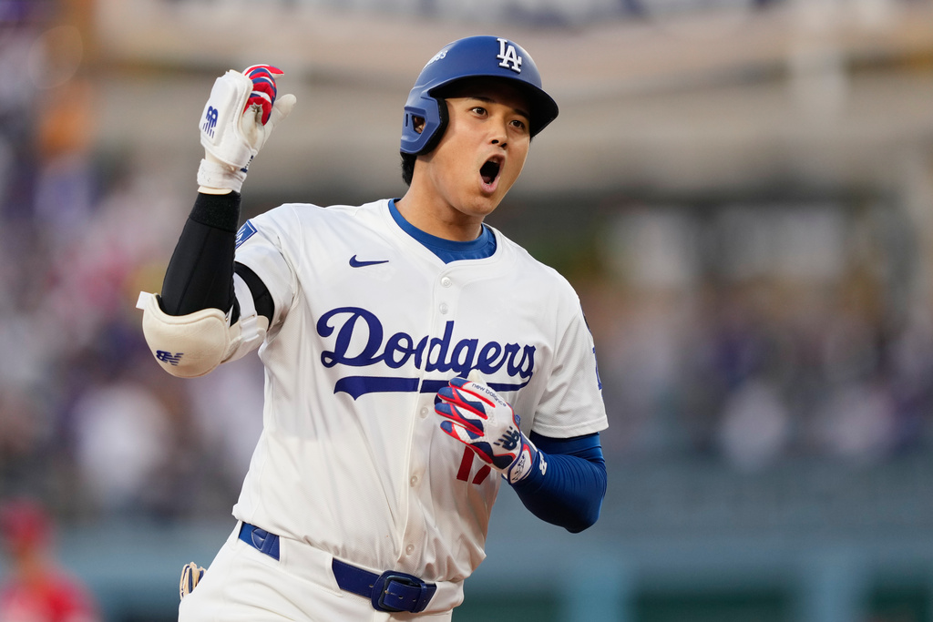 Los Angeles Dodgers' Shohei Ohtani celebrates as he rounds the bases after his solo home run during the first inning in Game 1 of the National League Wild Card baseball playoff series against the Cincinnati Reds, Tuesday, Sept. 30, 2025, in Los Angeles. (AP Photo/Mark J. Terrill)