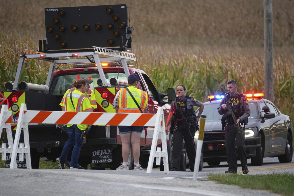 Pennsylvania state police troopers and emergency workers block a road after multiple police officers were shot and killed on Wednesday, Sept. 17, 2025, in North Codorus, Pa. (AP Photo/Matt Slocum)