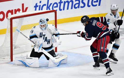 Utah Mammoth goaltender Vitek Vanecek (41) makes a save against Winnipeg Jets' Alex Iafallo (9) during the first period of an NHL hockey game in Winnipeg, Manitoba, Sunday, Oct. 26, 2025. (Fred Greenslade/The Canadian Press via AP) Utah Mammoth goaltender Vitek Vanecek (41) makes a save against Winnipeg Jets' Alex Iafallo (9) during the first period of an NHL hockey game in Winnipeg, Manitoba, Sunday, Oct. 26, 2025. (Fred Greenslade/The Canadian Press via AP)