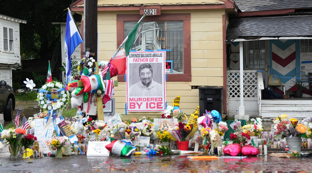A growing memorial at the site where Lorenzo Salgado Araujo was fatally shot by ICE agents last week, is seen Monday, July 13, 2026, in Houston. (AP Photo/Karen Warren)