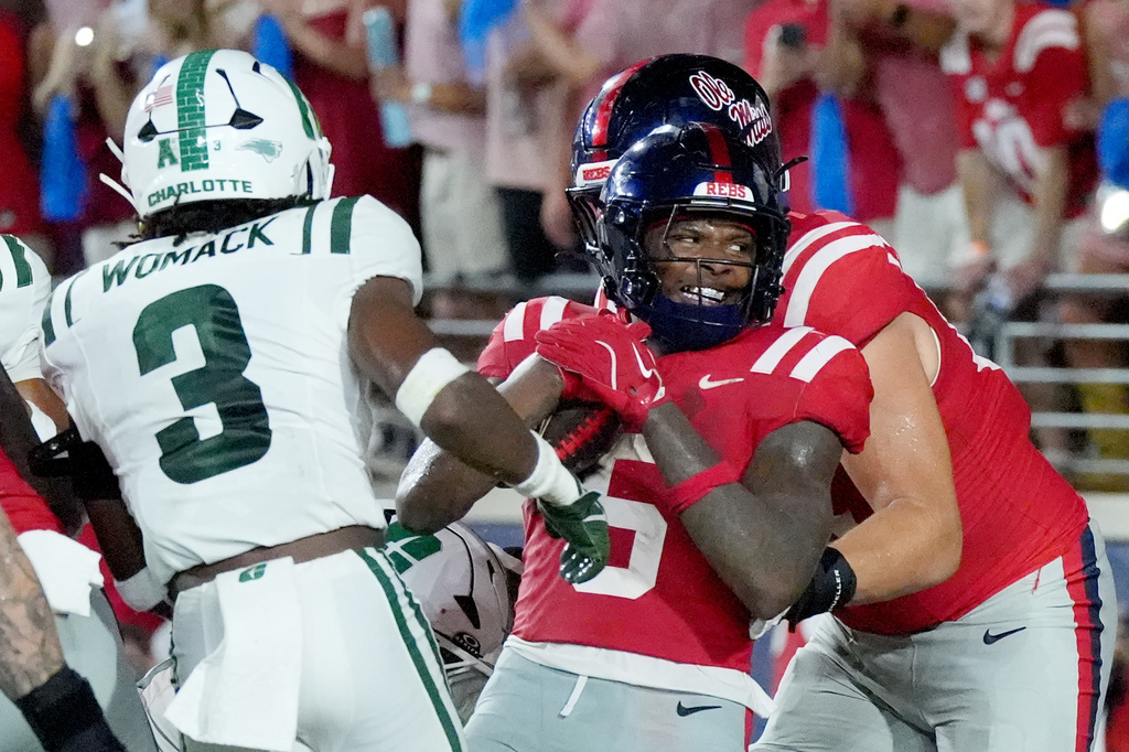 Mississippi running back Kewan Lacy (5) spins into the end zone for a two-yard rushing touchdown past Charlotte defensive back Dylon Womack (3) during the first half of an NCAA college football game against Charlotte in Oxford, Miss., Saturday, Sept. 12, 2026. (AP Photo/Rogelio V. Solis)