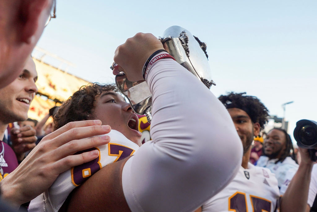 FILE -Arizona State wide receiver Zechariah Sample (87) celebrates with the Territorial Cup after beating Arizona in an NCAA college football game, Nov. 30, 2024, in Tucson, Ariz. (AP Photo/Samantha Chow, File)