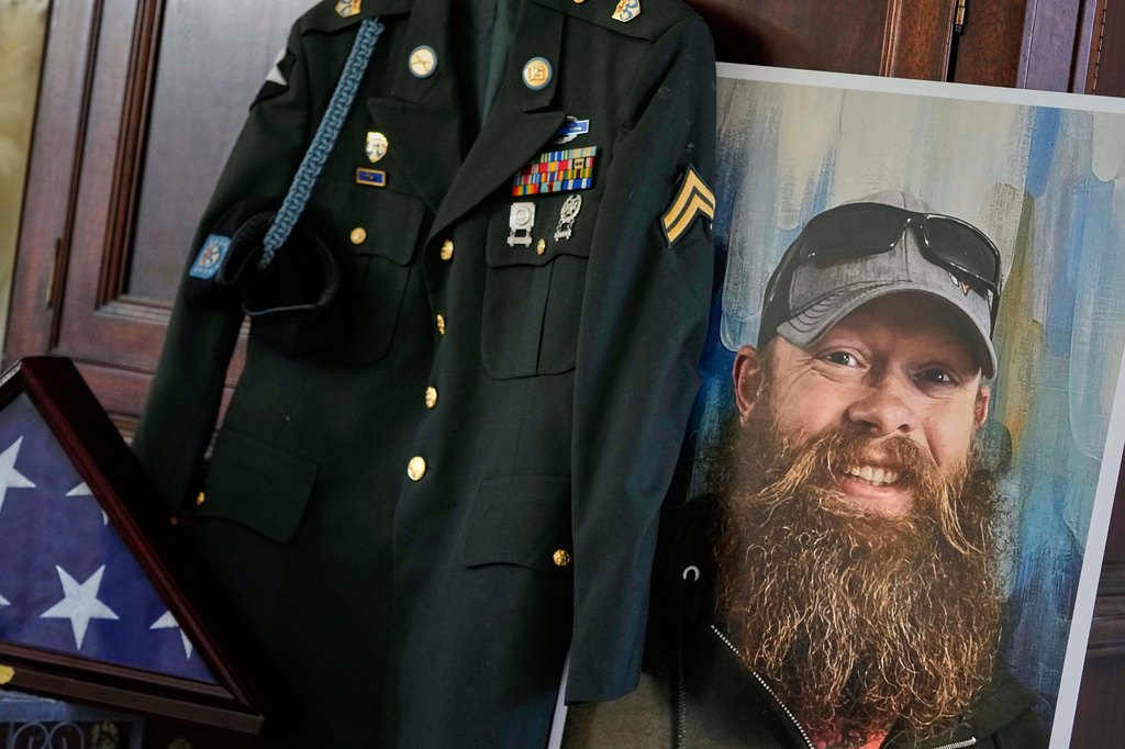 FILE - The Army dress uniform and photo of the late Christopher Pelkey is displayed at his mother's home, May 7, 2025, in Chandler, Ariz. (AP Photo/Matt York, File)