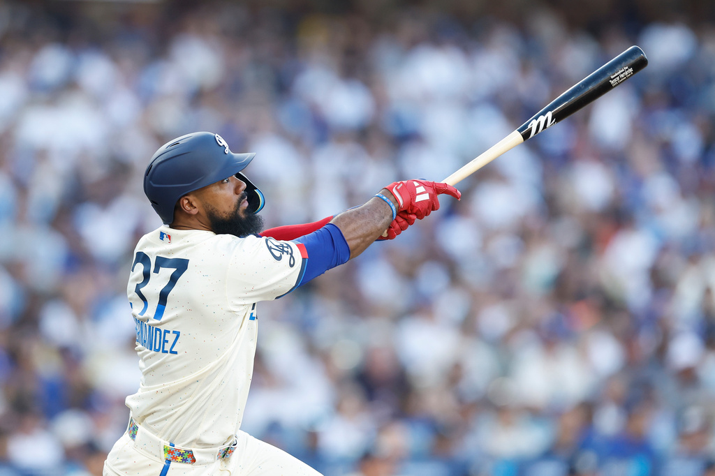 Los Angeles Dodgers' Teoscar Hernandez (37) watches the ball as he hits a two-run home run during the second inning of a baseball game against the Boston Red Sox, Saturday, Aug. 1, 2026, in Los Angeles. (AP Photo/Caroline Brehman)