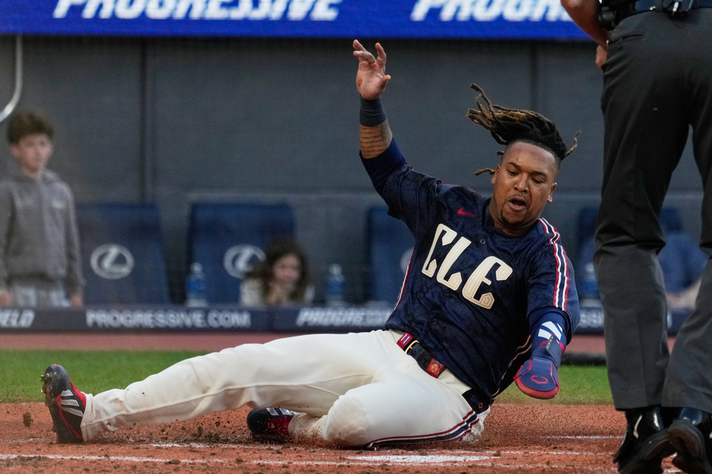 Cleveland Guardians' Jose Ramirez slies safely home in the first inning of a baseball game against the Boston Red Sox in Cleveland, Friday, May 29, 2026. (AP Photo/Sue Ogrocki)