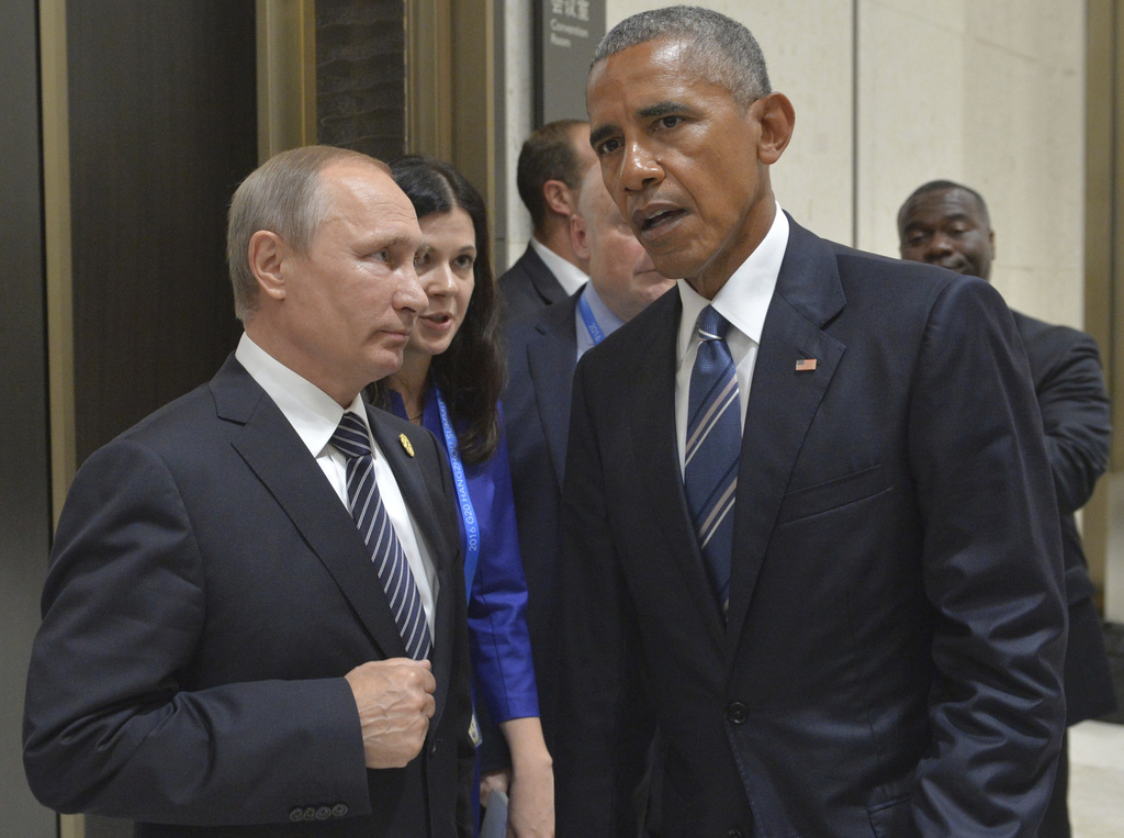 FILE - Russian President Vladimir Putin, left, listens to U.S. President Barack Obama in Hangzhou in eastern China's Zhejiang province, Monday, Sept. 5, 2016. (Alexei Druzhinin/Sputnik, Kremlin Pool Photo via AP, File)