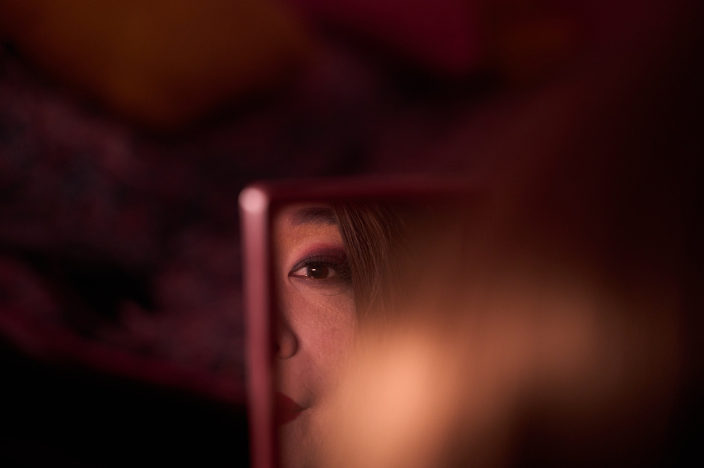 Rubi Lama, who is transgender and a former aid worker who turned to sex work to survive after losing her job amid the U.S. foreign aid cuts, applies makeup before going to work in the streets in Hetauda, Nepal, Friday, May 15, 2026. (AP Photo/Bram Janssen)