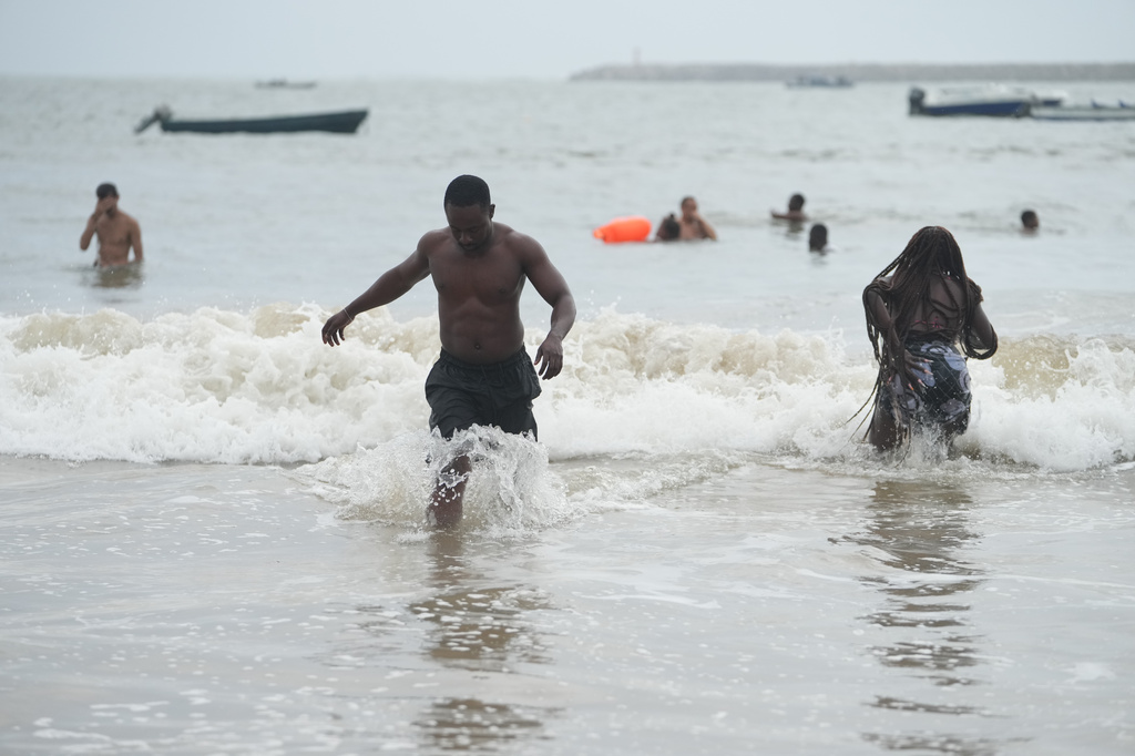 Mukthar Oladunmade, a 27-year-old writer, plays in the water at Takwa Bay beach in Lagos, Nigeria, Sunday, June 28, 2026. (AP Photo/Sunday Alamba)