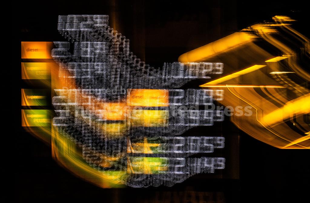Digital holographic fuel pump with glowing data streams and energy prices