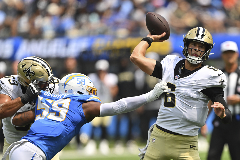 New Orleans Saints quarterback Tyler Shough (6) throws under pressure from Los Angeles Chargers linebacker Kylan Guidry (59) during the first half of a preseason NFL football game Sunday, Aug. 10, 2025, in Inglewood, Calif. (AP Photo/Jayne Kamin- Oncea)