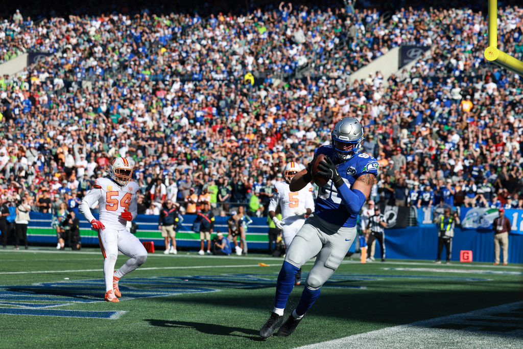 Seattle Seahawks tight end AJ Barner (88) scores a touchdown during the second half of an NFL football game against the Tampa Bay Buccaneers, Sunday, Oct. 5, 2025, in Seattle. (AP Photo/Maddy Grassy)