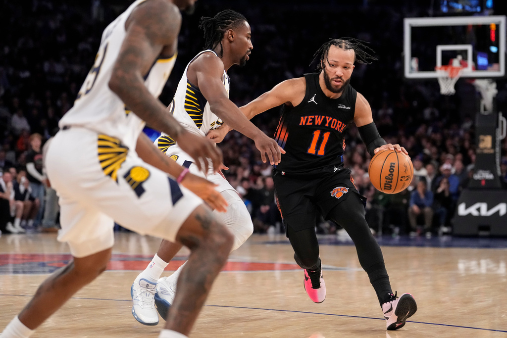 New York Knicks guard Jalen Brunson (11) drives past Indiana Pacers guard Aaron Nesmith during the second half of an NBA basketball game, Tuesday, Feb. 10, 2026, in New York. (AP Photo/Yuki Iwamura)
