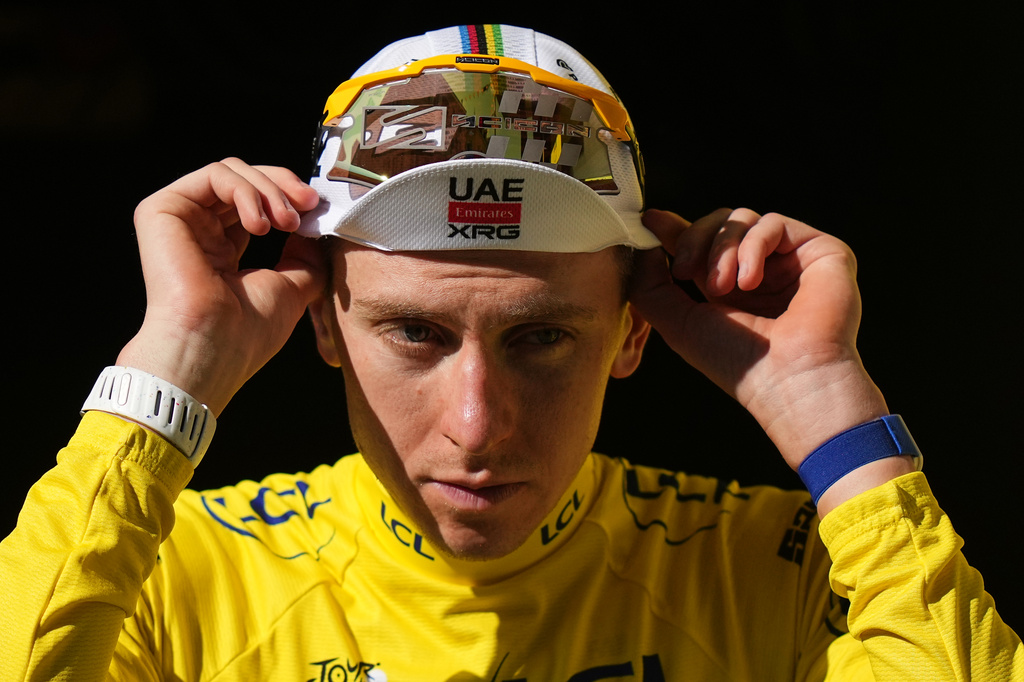 Slovenia's Tadej Pogacar, wearing the overall leader's yellow jersey arrives on the podium after the seventeenth stage of the Tour de France cycling race, with start in Chambery and finish in Voiron France, Wednesday, July 22, 2026. (AP Photo/Thibault Camus)