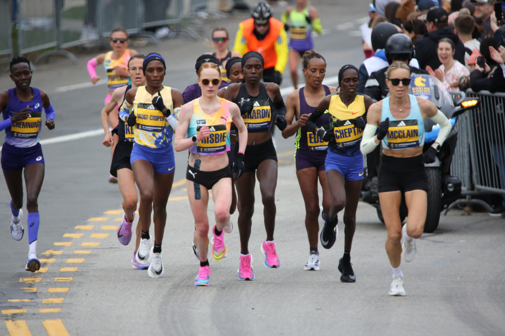 Jess McClain, right, runs in the lead pack on the Boston Marathon course in Newton, Mass., on Monday, April 20, 2026. (AP Photo/Jennifer McDermott)