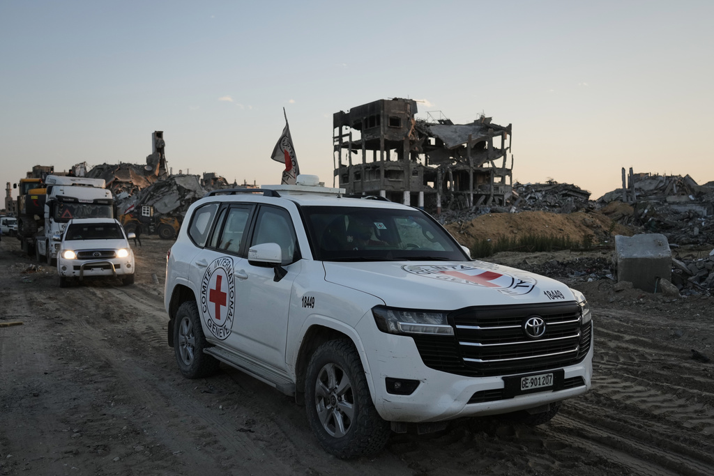 A Red Cross vehicle carrying what is believed to be the remains of a deceased hostage handed over by Hamas militants heads toward the border crossing with Israel for transfer to Israeli authorities, in Beit Lahiya in the northern Gaza Strip, Wednesday, Dec. 3, 2025. (AP Photo/Jehad Alshrafi)