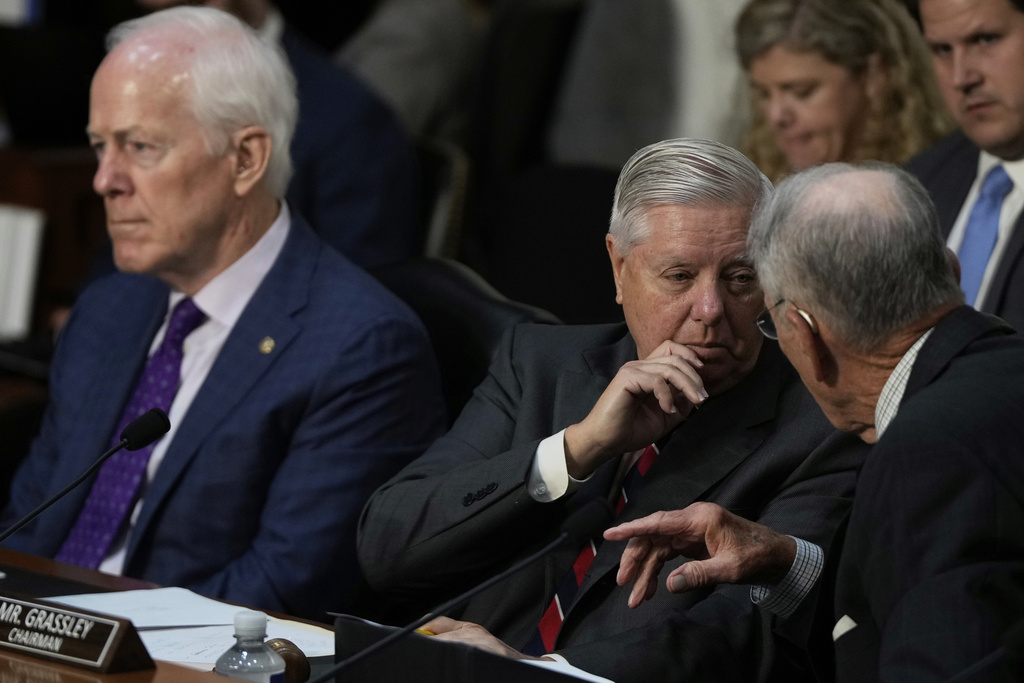 Sen. Lindsey Graham, R-S.C., center, talks to Sen. Chuck Grassley, R-Iowa, right, as FBI Director Kash Patel appears before the Senate Judiciary Committee for his first oversight hearing, Tuesday, Sept. 16, 2025, at the Capitol in Washington, as Sen. John Cornyn, R-Texas, left, looks on. (AP Photo/Julia Demaree Nikhinson)
