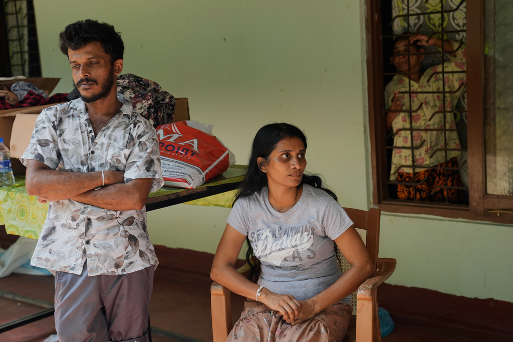 Workers who survived the nursing home fire Danuja Chathuranga, left, and Iresha Sandamali wait outside a nursing home, where inmates of another nursing home that caught fire on Wednesday are being temporarily housed, in Anguruwatota, Sri Lanka, Friday, June 5, 2026. (AP Photo/Eranga Jayawardena)