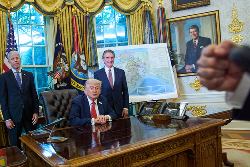 President Donald Trump congratulates a reporter on how young he looks, during an executive order signing in the Oval Office at the White House, Monday, Oct. 6, 2025, in Washington, as Energy Secretary Chris Wright, left, and Interior Secretary Doug Burgum listen. (AP Photo/Jacquelyn Martin) President Donald Trump congratulates a reporter on how young he looks, during an executive order signing in the Oval Office at the White House, Monday, Oct. 6, 2025, in Washington, as Energy Secretary Chris Wright, left, and Interior Secretary Doug Burgum listen. (AP Photo/Jacquelyn Martin)