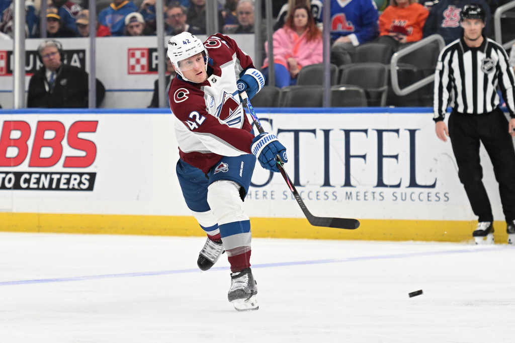 Colorado Avalanche's Josh Manson (42) takes a shot against the St. Louis Blues during the third period of an NHL hockey game, Tuesday, April 7, 2026, in St. Louis. (AP Photo/Joe Puetz)