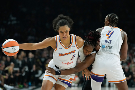 Phoenix Mercury forward Satou Sabally (0) works toward the basket as Las Vegas Aces guard Chelsea Gray (12), center, defends during the first half in Game 2 of the WNBA basketball finals, Sunday, Oct. 5, 2025, in Las Vegas. (AP Photo/John Locher) Phoenix Mercury forward Satou Sabally (0) works toward the basket as Las Vegas Aces guard Chelsea Gray (12), center, defends during the first half in Game 2 of the WNBA basketball finals, Sunday, Oct. 5, 2025, in Las Vegas. (AP Photo/John Locher)