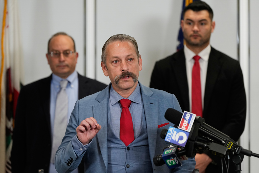 Attorney Mark P. Meuser, center, speaks to reporters during a press conference announcing a federal lawsuit challenging Proposition 50, Wednesday, Nov. 5, 2025, in Sacramento, Calif. (AP Photo/Godofredo A. Vásquez)