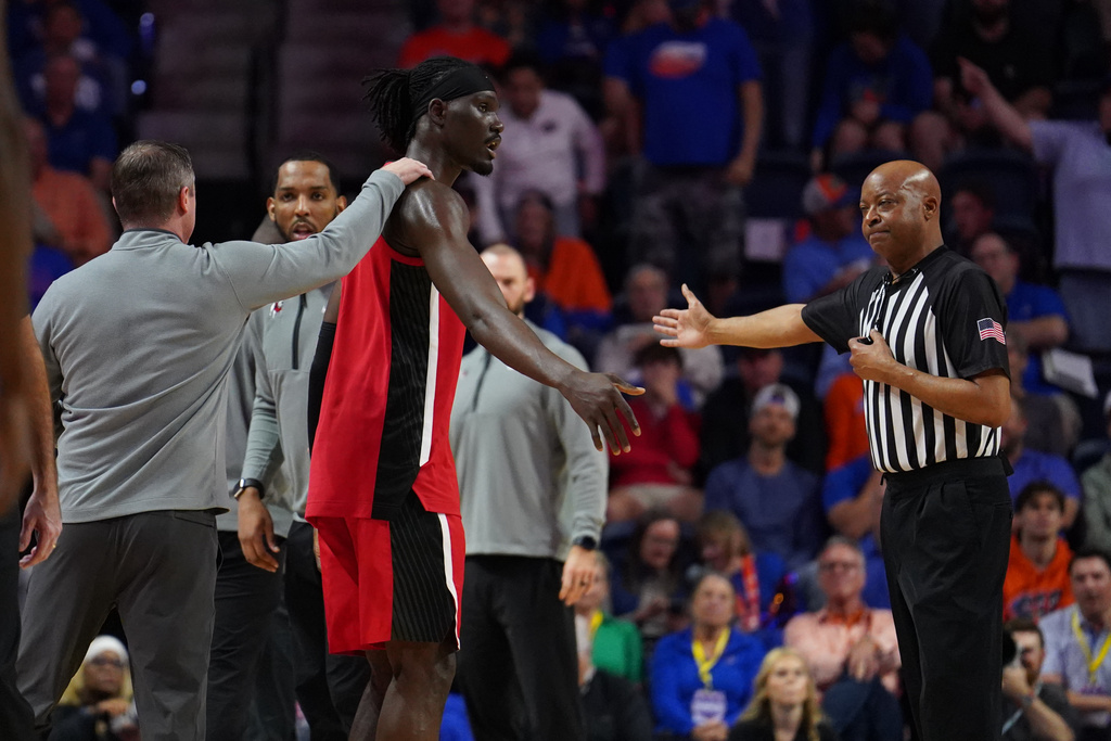 Georgia center Somtochukwu Cyril is ejected from the game after throwing a punch towards Florida player during the first half of an NCAA college basketball game Tuesday, Jan. 6, 2026, in Gainesville, Fla. (AP Photo/Morgan Hurd)