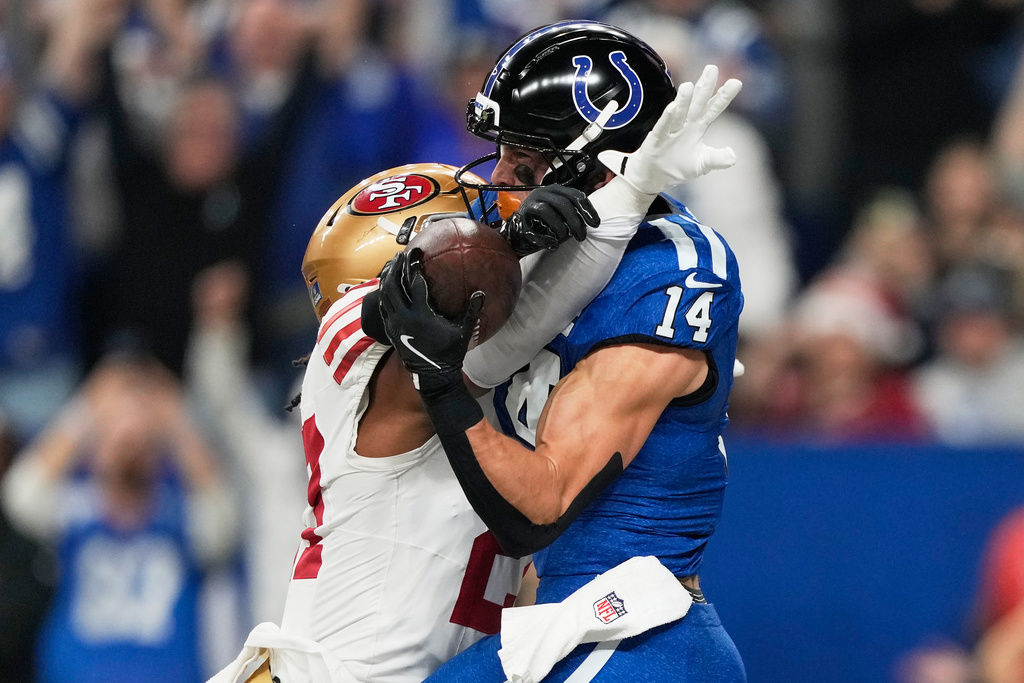 Indianapolis Colts wide receiver Alec Pierce (14) catches a touchdown pass against San Francisco 49ers safety Ji'Ayir Brown during the first half of an NFL football game, Monday, Dec. 22, 2025, in Indianapolis. (AP Photo/Carolyn Kaster)