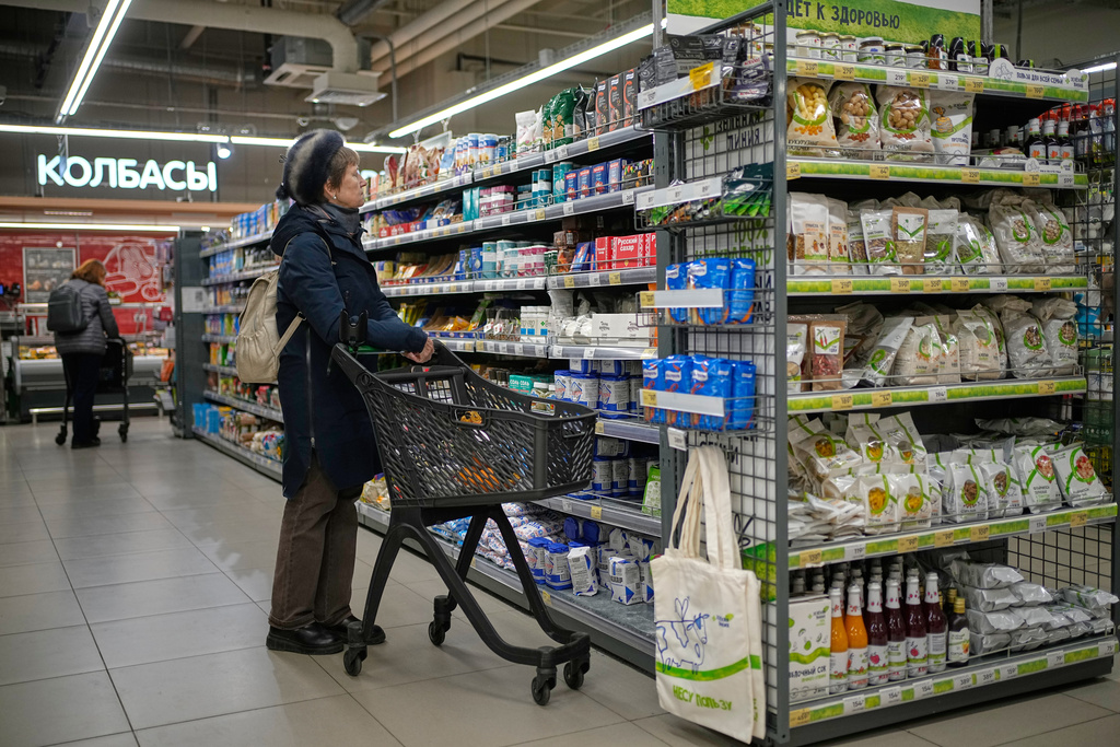 A woman chooses products in a supermarket in Moscow, Russia, Thursday, Nov. 20, 2025. (AP Photo/Pavel Bednyakov)