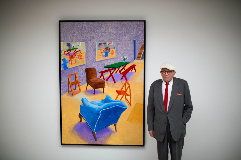 FILE - British artist David Hockney poses for photographers in front of his acrylic on canvas "Studio Interior #4" which features as part of the "David Hockney Painting and Photography" exhibition at the Annely Juda Fine Art gallery in London, Thursday, May 14, 2015. (AP Photo/Matt Dunham, File)
