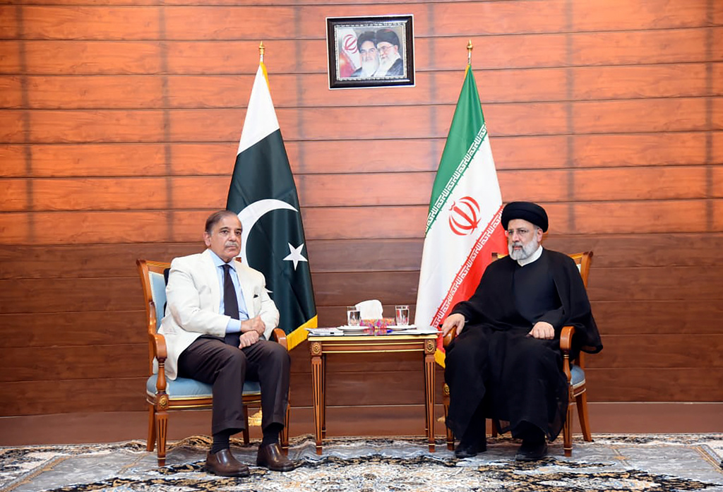 FILE - In this photo released by Pakistan Prime Minister Office, Pakistan's Prime Minister Shahbaz Sharif, left, and Iran's President Ebrahim Raisi meet during an inauguration of the Mand-Pishin border in Pishin, border of Pakistan-Iran, on May 18, 2023. (Pakistan Prime Minister Office via AP, File)