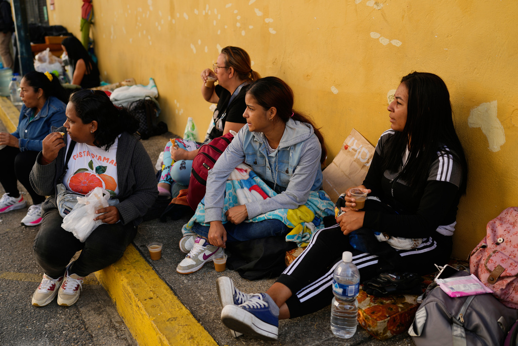 Relatives wait outside Zone 7 of the Bolivarian National Police, where political detainees are held, after spending the night there in Caracas, Venezuela, Monday, Jan. 12, 2026. (AP Photo/Ariana Cubillos)