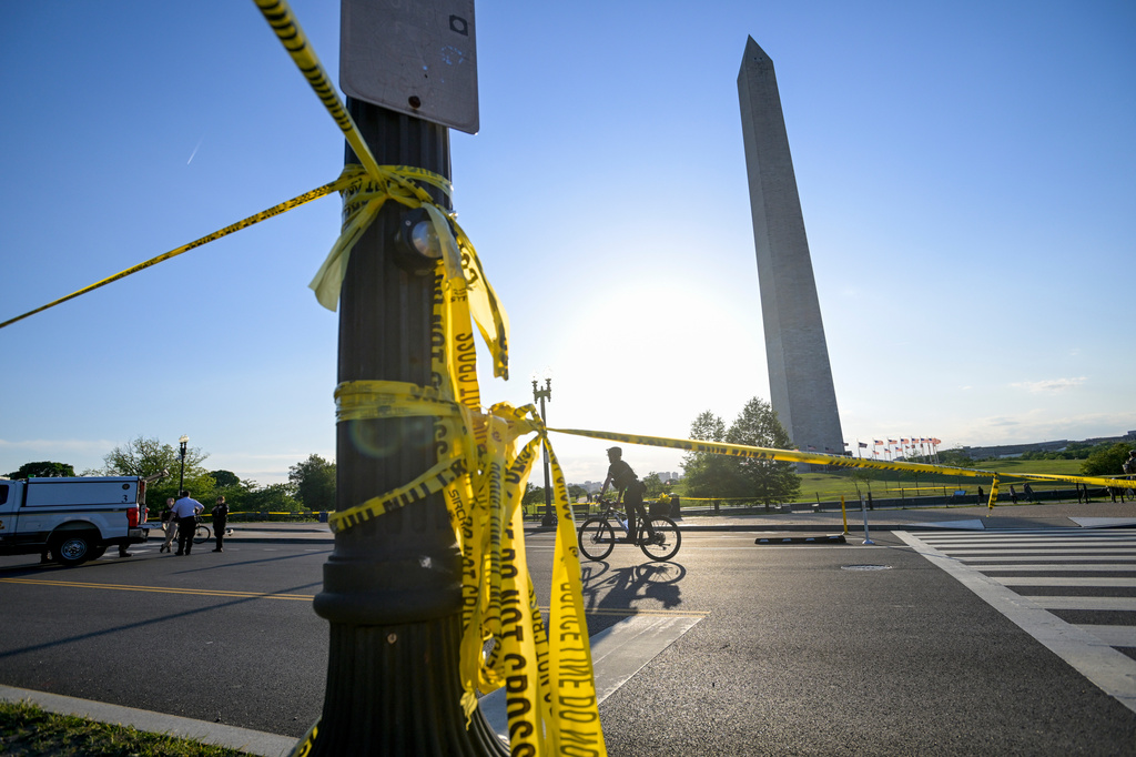 FILE - Police tape remains around the scene after a person was shot near the Washington Monument in May 4, 2026, in Washington. (AP Photo/Rod Lamkey Jr., File)