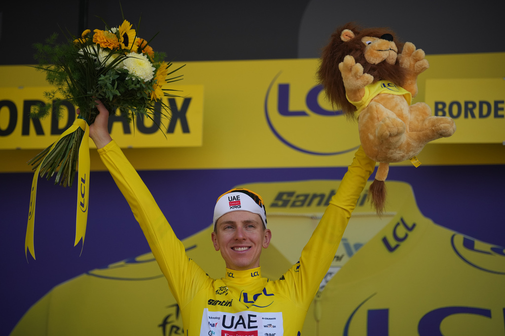Slovenia's Tadej Pogacar, wearing the overall leader's yellow jersey celebrates on the podium after the seventh stage of the Tour de France cycling race with start in Hagetmau and finish in Bordeaux, France, Friday, July 10, 2026. (AP Photo/Mosa'ab Elshamy)