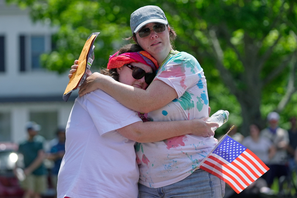Biddeford City Councilor Abigail Woods hugs an unidentified constituent during an impromptu protest near the scene of a shooting involving U.S. Immigration and Customs Enforcement, Monday, July 13, 2026 in Biddeford, Maine. (AP Photo/Robert F. Bukaty)