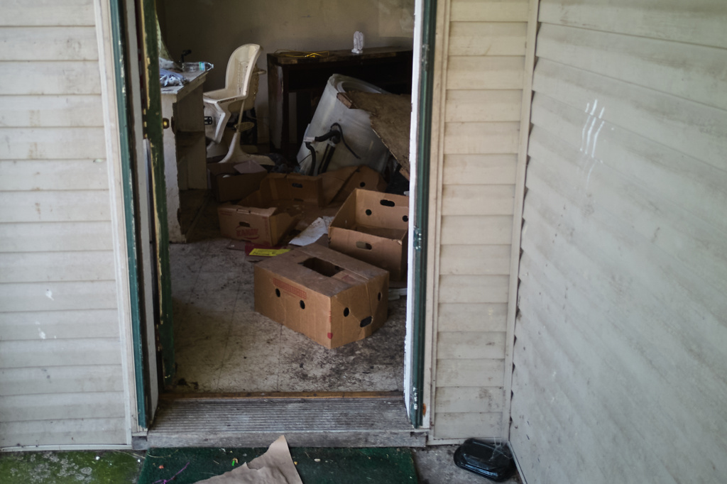 Items including a high chair are seen in a home where authorities say they removed 16 children and arrested four adults in Hamden, Ohio, Wednesday, July 1, 2026. (AP Photo/Carolyn Kaster)