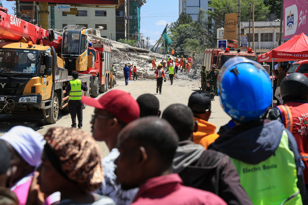 A rescue team works at the scene of a collapsed building in Nairobi, Kenya, Friday, Jan. 2, 2026. (AP Photo/Andrew Kasuku)