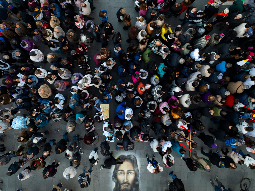 People participate in a procession marking the Catholic feast of Corpus Christi in Plaza de Armas in Santiago, Chile, Sunday, June 7, 2026. (AP Photo/Esteban Felix)