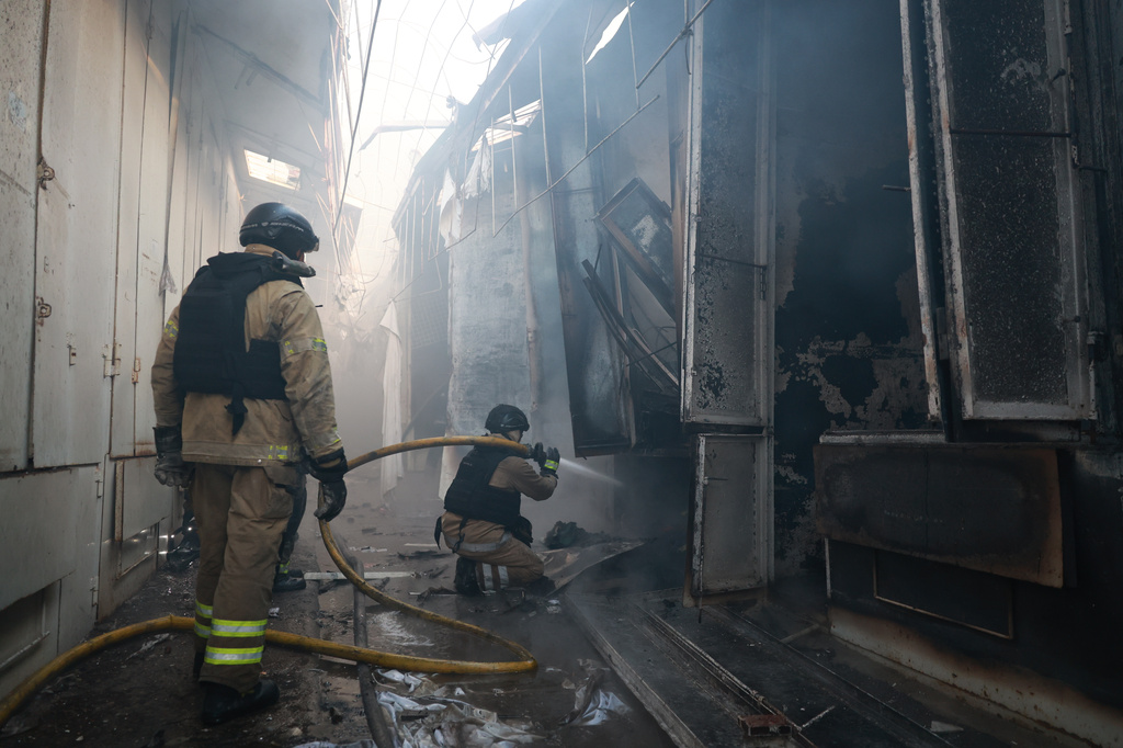 Rescue workers put-out a fire of the central market damaged in a Russian strike on Zaporizhzhia, Ukraine, on Saturday, Sept. 26, 2026. (AP Photo/Kateryna Klochko)