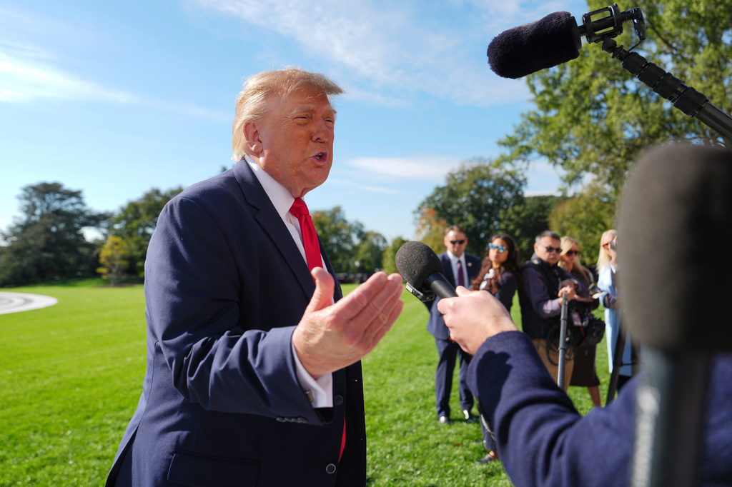 President Donald Trump speaks with reporters before boarding Marine One on the South Lawn of the White House, Friday, Oct. 23, 2026, in Washington. (AP Photo/Julia Demaree Nikhinson)