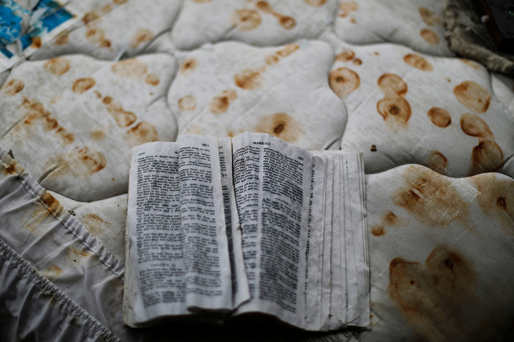 FILE - A bible sits on a stained mattress on a pile of debris outside a damaged motel from Hurricane Michael in Panama City, Fla, Jan. 23, 2019. (AP Photo/David Goldman, File)