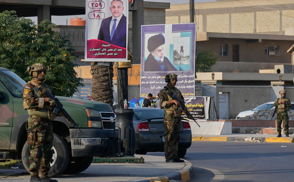 Iraqi army soldiers patrol Sadr City, Baghdad, during parliamentary elections, Tuesday, Nov. 11, 2025. (AP Photo/Hadi Mizban)