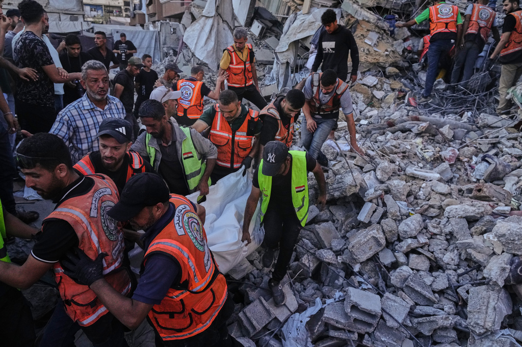 Palestinian civil defense crews carry a body from the rubble of a collapsed building that housed displaced Palestinians and was heavily damaged during the Israel-Hamas war, in Gaza City, Wednesday, Sept. 16, 2026. (AP Photo/Jehad Alshrafi)