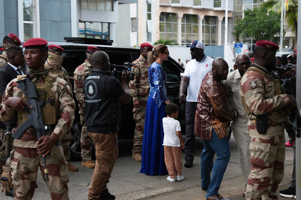 Guinea's interim President, Gen. Mamadi Doumbouya, arrives with his family to cast his vote in the constitutional referendum, in Conakry, Guinea, Sunday, Sept. 21, 2025. (AP Photo/Misper Apawu)
