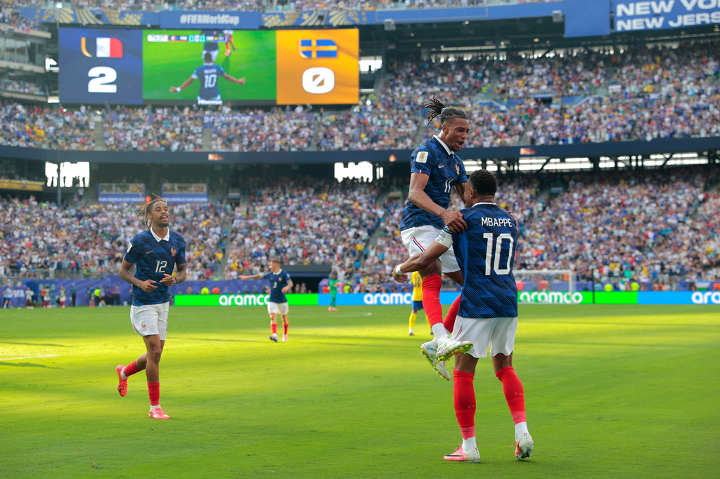 France's Kylian Mbappe (10) celebrates scoring their third goal with Michael Olise (11) during the World Cup round of 32 soccer match between France and Sweden in East Rutherford, N.J., near New York, Tuesday, June 30, 2026. (AP Photo/Pamela Smith)