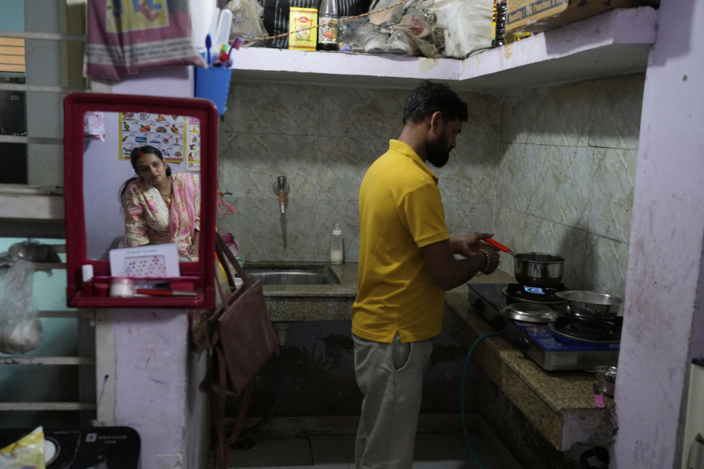 Rajkumar Varma, trained in Care Companion Program (CCP), makes tea for his pregnant wife Anju Varma at home in Gurugram, a satellite city of New Delhi, India, on Aug. 8, 2025. (AP Photo/Manish Swarup)