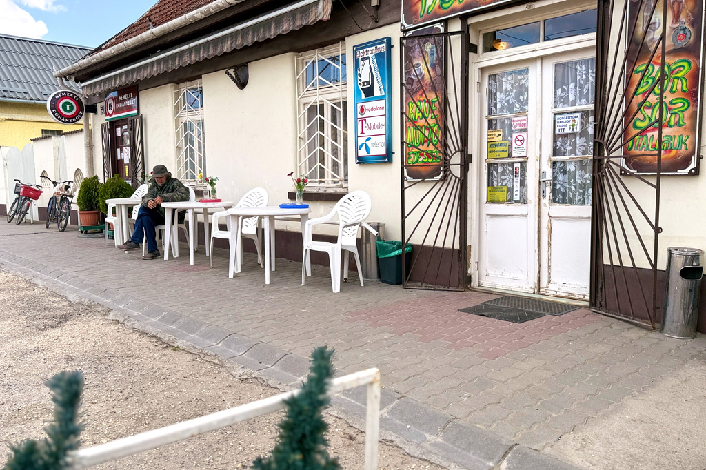 A man sits outside a coffee shop in Albertirsa, Hungary, Thursday, April 9, 2026. (AP Photo/Eldar Emric)
