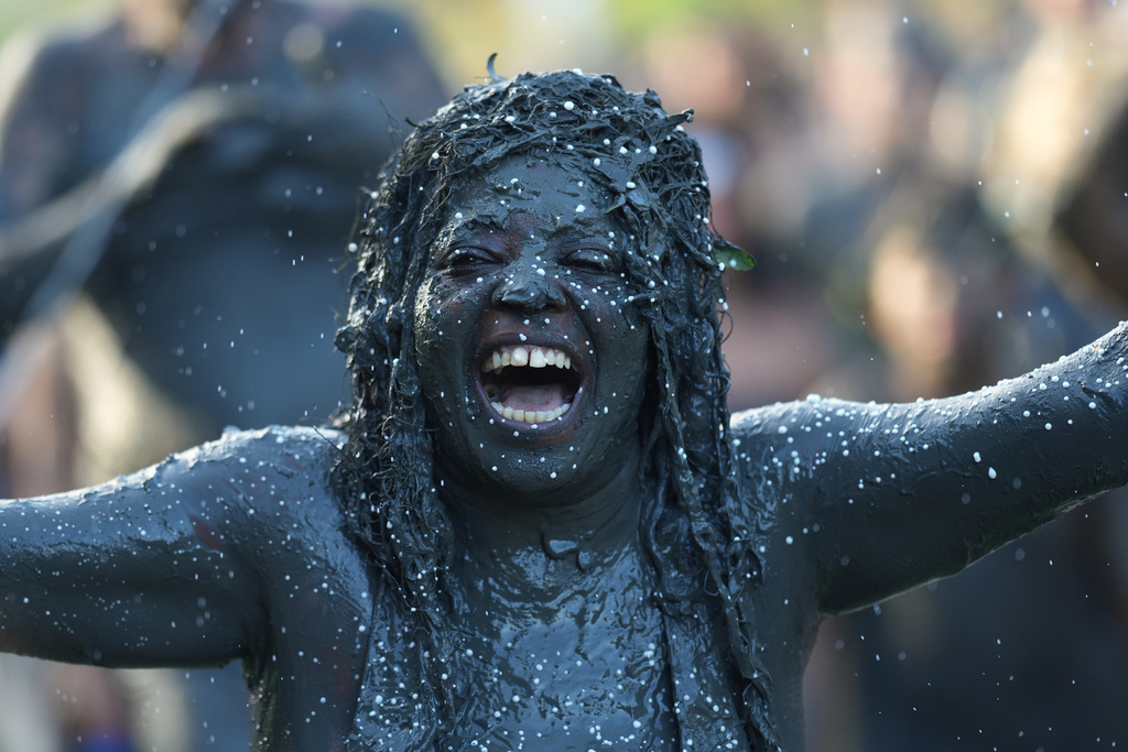 A reveler celebrates during the Mud Block carnival party in Paraty, Brazil, Saturday, Feb. 14, 2026. (AP Photo/Andre Penner)