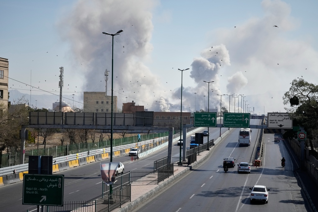 Plumes of smoke rise as strikes hit the city during the U.S.–Israeli military campaign in Tehran, Iran, Thursday, March 5, 2026. (AP Photo/Vahid Salemi)