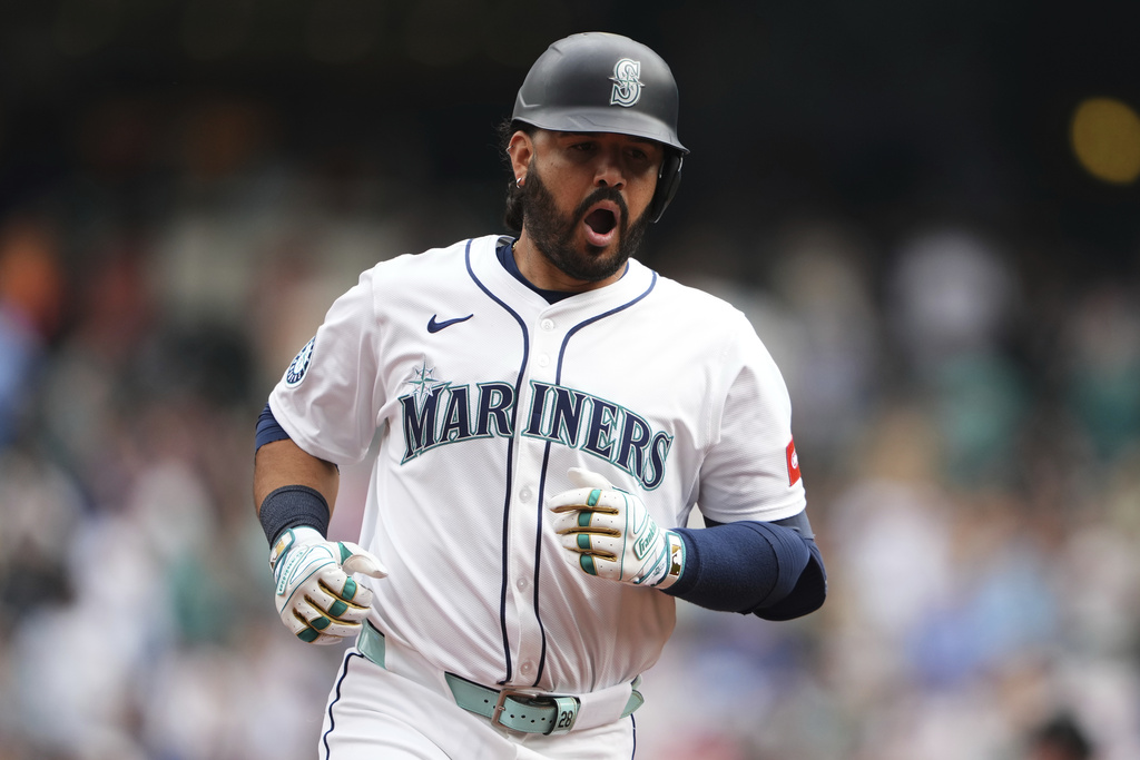 Seattle Mariners' Eugenio Suarez celebrates while running the bases after hitting a three-run home run during the fourth inning of a baseball game against the San Diego Padres, Wednesday, Aug. 27, 2025, in Seattle. (AP Photo/Lindsey Wasson)
