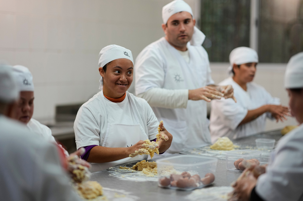 Camila Da Silva makes cakes at a nonprofit center that supports people with disabilities, in Moreno on the outskirts of Buenos Aires, Argentina, Tuesday, May 5, 2026. (AP Photo/Natacha Pisarenko)